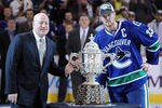 VANCOUVER, CANADA - MAY 24:  NHL Deputy Commissioner Bill Daly and Captain Henrik Sedin #33 of the Vancouver Canucks pose with the Clarence Campbell Bowl after the Vancouver Canucks defeated the San Jose Sharks 3-2 in double-overtime in Game Five to win the Western Conference Finals series 4-1 during the 2011 Stanley Cup Playoffs at Rogers Arena on May 24, 2011 in Vancouver, British Columbia, Canada. Bieksa got the game-winning goal in the second overtime to win the series 4-1.  (Photo by Harry How/Getty Images)