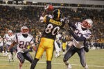 PITTSBURGH - JANUARY 23:   Wide receiver Plaxico Burress #80 of the Pittsburgh Steelers can't hang on to a pass while being defended by defensive backs Eugene Wilson #26 and Asante Samuel #22 of the New England Patriots in the AFC championship game at Heinz Field on January 23, 2005 in Pittsburgh, Pennsylvania. The Patriots defeated the Steelers 41-27. (Photo by Andy Lyons/Getty Images)