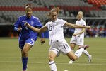 VANCOUVER, CANADA - JANUARY 20: Lissy Sanchez #4 of the Dominican Republic looks on as Alex Morgan #13 of the United States kicks the ball during their game at the CONCACAF Women's Olympic Qualifying Tournament at BC Place on January 20, 2012 in Vancouver, British Columbia, Canada. (Photo by Jeff Vinnick/Getty Images)