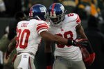 GREEN BAY, WI - JANUARY 15:   Victor Cruz #80 of the New York Giants celebrates with teammate Hakeem Nicks #88 after a play against the Green Bay Packers during their NFC Divisional playoff game at Lambeau Field on January 15, 2012 in Green Bay, Wisconsin.  (Photo by Jonathan Daniel/Getty Images)