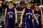INDIANAPOLIS, IN - MARCH 11:  (L-R) John Shurna #24, Alex Marcotullio #4 and Luka Mirkovic #12 of the Northwestern Wildcats walk up court dejected during overtime against the Ohio State Buckeyes during the quarterfinals of the 2011 Big Ten Men's Basketball Tournament at Conseco Fieldhouse on March 11, 2011 in Indianapolis, Indiana.  (Photo by Chris Chambers/Getty Images)