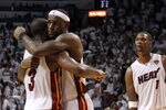 MIAMI, FL - MAY 31:  LeBron James #6 and Dwyane Wade #3 of the Miami Heat hug alongside teammate Chris Bosh #1 of the Miami Heat after the Heat defeat the Dallas Mavericks 92-84 in Game One of the 2011 NBA Finals at American Airlines Arena on May 31, 2011 in Miami, Florida. NOTE TO USER: User expressly acknowledges and agrees that, by downloading and/or using this Photograph, user is consenting to the terms and conditions of the Getty Images License Agreement.  (Photo by Mike Ehrmann/Getty Images)