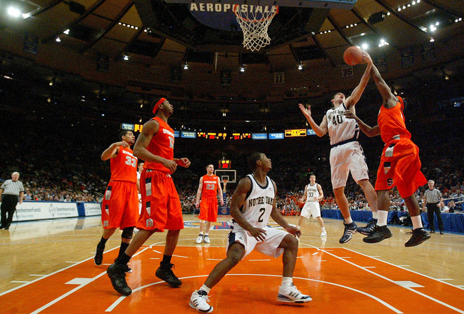 NEW YORK - MARCH 08:   Paul Harris #11 of the Syracuse Orange blocks the shot Luke Zeller #40 of the Notre Dame Fighting Irish during the quarterfinals of the Big East Championship at Madison Square Garden On March 8, 2007 in New York City.  (Photo by Jim McIsaac/Getty Images)