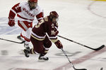 DETROIT - APRIL 10:  Cam Atkinson #13 of the Boston College Eagles gets around Cody Goloubef #27 of the Wisconsin Badgers during the championship game of the 2010 NCAA Frozen Four on April 10, 2010 at Ford Field in Detroit, Michigan. Boston College won the game 5-0. (Photo by Gregory Shamus/Getty Images)