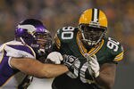 GREEN BAY, WI - NOVEMBER 14:  B.J. Raji #90 of the Green Bay Packers rushes against John Sullivan #65 of the Minnesota Vikings at Lambeau Field on November 14, 2011 in Green Bay, Wisconsin. The Packers defeated the Vikings 45-7.  (Photo by Jonathan Daniel/Getty Images)