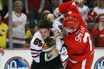 DETROIT, MI - MARCH 4:  Andrew Shaw #65 of the Chicago Blackhawks takes a punch to the head from Brendan Smith #2 of the Detroit Red Wings during their NHL game at Joe Louis Arena on March 4, 2012 in Detroit, Michigan.  (Photo by Dave Sandford/Getty Images)