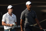ABU DHABI, UNITED ARAB EMIRATES - JANUARY 28:  Rory McIlroy of Northern Ireland and Tiger Woods of the USA during the third round of Abu Dhabi HSBC Golf Championship at the Abu Dhabi HSBC Golf Championship on January 28, 2012 in Abu Dhabi, United Arab Emirates.  (Photo by Ross Kinnaird/Getty Images)