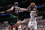 ATLANTA - MAY 2:  Guard Jamal Crawford #11 of the Atlanta Hawks shoots over guard Luke Ridnour #13 of the Milwaukee Bucks during Game Seven of the Eastern Conference Quarterfinals between the Milwaukee Bucks and the Atlanta Hawks during the 2010 NBA Playoffs at Philips Arena on May 2, 2010 in Atlanta, Georgia. The Hawks beat the Bucks 95-74.  NOTE TO USER: User expressly acknowledges and agrees that, by downloading and/or using this photograph, user is consenting to the terms and conditions of the Getty Images License Agreement.  (Photo by Mike Zarrilli/Getty Images)