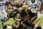 NEW ORLEANS, LA - JANUARY 1: DeAngelo Williams #34 of the Carolina Panthers is tackled by members the New Orleans Saints Defense at the Mercedes-Benz Superdome on January 1, 2012 in New Orleans, Louisiana  (Photo by Scott Cunningham/Getty Images)