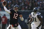CHICAGO, IL - DECEMBER 18:  Caleb Hanie #12 of the Chicago Bears throws a pass as Chris Clemons #91 of the Seattle Seahawks closes in at Soldier Field on December18, 2011 in Chicago, Illinois. The Seahawks defeated the Bears 38-14.  (Photo by Jonathan Daniel/Getty Images)