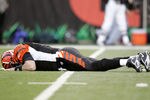 CINCINNATI - JANUARY 08:  Quarterback Carson Palmer #9 of the Cincinnati Bengals lays on the ground after being hit in the knee on the first drive of the AFC Wild Card Playoff Game against the Pittsburgh Steelers at Paul Brown Stadium on January 8, 2006 in Cincinnati, Ohio.   The Steelers defeated the Bengals 31-17.  (Photo by Andy Lyons/Getty Images)