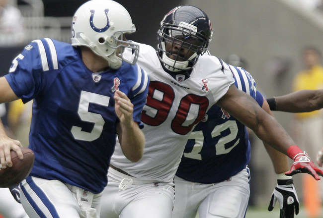 HOUSTON, TX - SEPTEMBER 11: Quarterback Kerry Collins #5 of the Indianapolis Colts is chased down by linebacker Mario Williams #90 and defensive end Antonio Smith #94 of the Houston Texans on September 11, 2011 at Reliant Stadium in Houston, Texas. Texans won 34 to 7. (Photo by Thomas B. Shea/Getty Images)