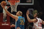 CHICAGO, IL - FEBRUARY 28: Chris Kaman #35 of the New Orleans Hornets puts up a shot past Joakim Noah #13 of the Chicago Bulls at the United Center on February 28, 2012 in Chicago, Illinois. NOTE TO USER: User expressly acknowledges and agrees that, by downloading and or using this photograph, User is consenting to the terms and conditions of the Getty Images License Agreement. (Photo by Jonathan Daniel/Getty Images)