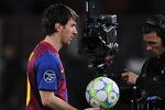 BARCELONA, SPAIN - MARCH 07:  Lionel Messi of FC Barcelona holds the ball after scoring 5 goals, followed by a camera man at the end of the UEFA Champions League round of 16 second leg match between FC Barcelona and Bayern 04 Leverkusen at Camp Nou on March 7, 2012 in Barcelona, Spain. FC Barcelona won 7-1 and Lionel Messi scored 5 goals.  (Photo by David Ramos/Getty Images)