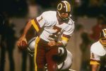 22  Jan 1984:  Quarterback Joe Theismann  #7 of the Washington Redskins charges off with the ball during Super Bowl XVIII against the Los Angeles Raiders at Tampa Stadium in Tampa, Florida.The Raiders won the game, 38-9. Mandatory Credit: Allsport  /Allsp