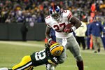 GREEN BAY, WI - JANUARY 15:  Brandon Jacobs #27 of the New York Giants runs with the ball against Morgan Burnett #42 of the Green Bay Packers during their NFC Divisional playoff game at Lambeau Field on January 15, 2012 in Green Bay, Wisconsin.  (Photo by Jonathan Daniel/Getty Images)
