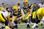 ARLINGTON, TX - FEBRUARY 06:  Aaron Rodgers #12 of the Green Bay Packers calls signals at the line of scrimmage under center Scott Wells #63 against the Pittsburgh Steelers during Super Bowl XLV at Cowboys Stadium on February 6, 2011 in Arlington, Texas.  (Photo by Kevin C. Cox/Getty Images)