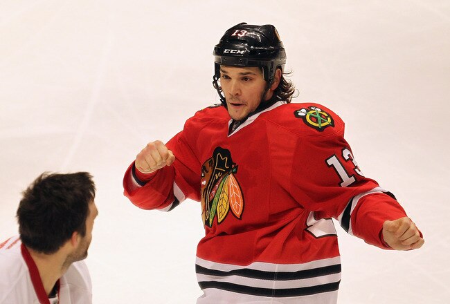 CHICAGO, IL - DECEMBER 30: Daniel Carcillo #13 of the Chicago Blackhawks squares off against Todd Bertuzzi #44 of the Detroit Red Wings at the United Center on December 30, 2011 in Chicago, Illinois. (Photo by Jonathan Daniel/Getty Images)