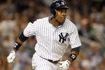 NEW YORK, NY - AUGUST 10:  Curtis Granderson #14 of the New York Yankees watches his second homerun of the game against the Los Angeles Angels of Anaheim on August 10, 2011 at Yankee Stadium in the Bronx borough of New York City.  (Photo by Mike Stobe/Getty Images)