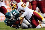 PHILADELPHIA, PA - JANUARY 01:   Oshiomogho Atogwe #20 of the Washington Redskins tackles Dion Lewis #28 of the Philadelphia Eagles during a game at Lincoln Financial Field on January 1, 2012 in Philadelphia, Pennsylvania.  (Photo by Patrick McDermott/Getty Images)