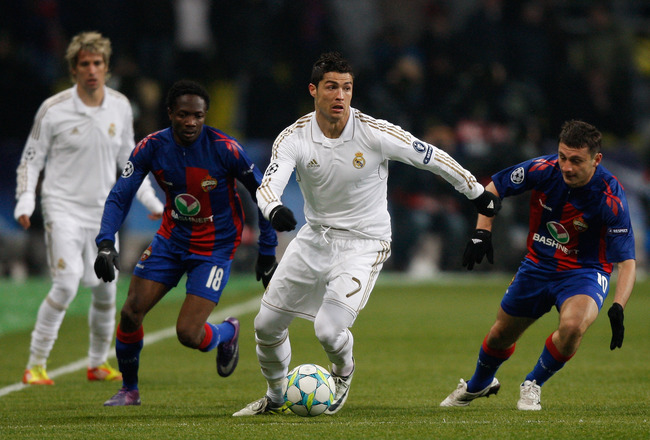 MOSCOW, RUSSIA - FEBRUARY 21: Cristiano Ronaldo (C) of Real Madrid runs with the ball past Ahmed Musaab (2nd L) and Alan Dzagoev (R) of CSKA Moskva during the UEFA Champions League round of 16, first leg match between CSKA Moscow and Real Madrid at the Luzhniki Stadium on February 21, 2012 in Moscow, Russia.  (Photo by Harry Engels/Getty Images)