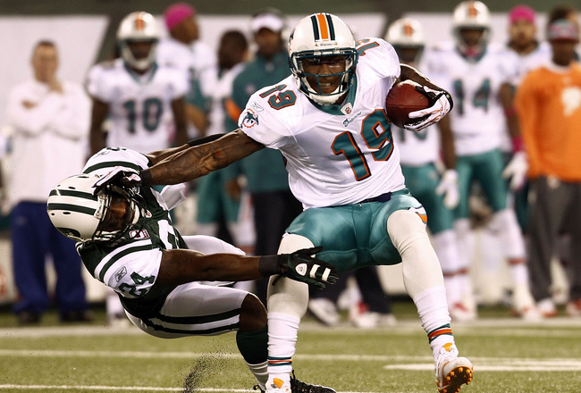 EAST RUTHERFORD, NJ - OCTOBER 17:  Brandon Marshall #19 of the Miami Dolphins hits Darrelle Revis #24 of the New York Jets  during their game at MetLife Stadium on October 17, 2011 in East Rutherford, New Jersey.  (Photo by Jeff Zelevansky/Getty Images)