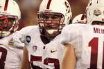 GLENDALE, AZ - JANUARY 02:  David DeCastro #52 of the Stanford Cardinal listens to Andrew Luck (L) #12 call a play in the huddle during the Tostitos Fiesta Bowl on January 2, 2012 at University of Phoenix Stadium in Glendale, Arizona.  (Photo by Donald Miralle/Getty Images)