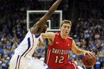 KANSAS CITY, MO - DECEMBER 19:  Nik Cochran #12 of the Davidson Wildcats drives as Tyshawn Taylor #10 of the Kansas Jayhawks defends during the game on December 19, 2011 at the Sprint Center in Kansas City, Missouri.  (Photo by Jamie Squire/Getty Images)