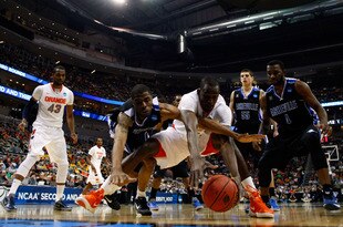 PITTSBURGH, PA - MARCH 15:  Baye Keita #12 of the Syracuse Orange fights for the ball against Jaron Lane #5 of the UNC Asheville Bulldogs during the second round of the 2012 NCAA Men's Basketball Tournament at Consol Energy Center on March 15, 2012 in Pittsburgh, Pennsylvania.  (Photo by Gregory Shamus/Getty Images)