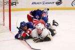 NEW YORK, NY - MARCH 15:  Sidney Crosby #87 of the Pittsburgh Penguins slides across the ice alongside Steve Eminger #44 of the New York Rangers at Madison Square Garden on March 15, 2012 in New York City.  (Photo by Nick Laham/Getty Images)