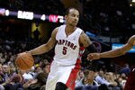 CLEVELAND, OH - DECEMBER 26:  Jerryd Bayless #5 of the Toronto Raptors handles the ball against Ramon Sessions #3 of the Cleveland Cavaliers during the season opener at Quicken Loans Arena on December 26, 2011 in Cleveland, Ohio. NOTE TO USER: User expressly acknowledges and agrees that, by downloading and or using this photograph, User is consenting to the terms and conditions of the Getty Images License Agreement.  (Photo by Mike Lawrie/Getty Images)
