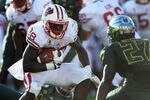 PASADENA, CA - JANUARY 02:  Running back Montee Ball #28 of the Wisconsin Badgers runs the ball against Terrance Mitchell #27 of the Oregon Ducks in the second quarter at the 98th Rose Bowl Game on January 2, 2012 in Pasadena, California.  (Photo by Harry How/Getty Images)