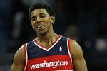 CHARLOTTE, NC - JANUARY 28:  Teammates Nick Young #1 and John Wall #2 of the Washington Wizards react to a play on their way to defeating the Charlotte Bobcats 102-99 during their game at Time Warner Cable Arena on January 28, 2012 in Charlotte, North Carolina. NOTE TO USER: User expressly acknowledges and agrees that, by downloading and or using this photograph, User is consenting to the terms and conditions of the Getty Images License Agreement.  (Photo by Streeter Lecka/Getty Images)