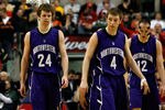INDIANAPOLIS, IN - MARCH 11:  (L-R) John Shurna #24, Alex Marcotullio #4 and Luka Mirkovic #12 of the Northwestern Wildcats walk up court dejected during overtime against the Ohio State Buckeyes during the quarterfinals of the 2011 Big Ten Men's Basketball Tournament at Conseco Fieldhouse on March 11, 2011 in Indianapolis, Indiana.  (Photo by Chris Chambers/Getty Images)
