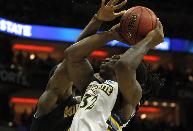 LOUISVILLE, KY - MARCH 17:  Jae Crowder #32 of the Marquette Golden Eagles is fouled by Ivan Aska #42 of the Murray State Racers in the second half during the third round of the 2012 NCAA Men's Basketball Tournament at KFC YUM! Center on March 15, 2012 in Louisville, Kentucky.  (Photo by Jonathan Daniel/Getty Images)
