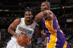 DENVER, CO - FEBRUARY 03:  Nene Hilario #31 of the Denver Nuggets drives to the basket against Andrew Bynum #17 of the Los Angeles Lakers at the Pepsi Center on February 3, 2012 in Denver, Colorado. NOTE TO USER: User expressly acknowledges and agrees that, by downloading and or using this photograph, User is consenting to the terms and conditions of the Getty Images License Agreement.  (Photo by Doug Pensinger/Getty Images)