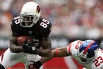 GLENDALE, AZ - OCTOBER 02:  Early Doucet #85 of the Arizona Cardinals runs with the ball as Corey Webster #23 of the New York Giants tries to make the tackle at University of Phoenix Stadium on October 2, 2011 in Glendale, Arizona.  (Photo by Christian Petersen/Getty Images)