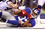 EAST RUTHERFORD, NJ - SEPTEMBER 19:  Domenik Hixon #87 of the New York Giants catches a 22-yard touchdown reception in the second quarter against Craig Dahl #43 of the St. Louis Rams at MetLife Stadium on September 19, 2011 in East Rutherford, New Jersey.  (Photo by Al Bello/Getty Images)