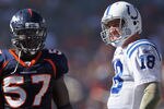 DENVER - SEPTEMBER 26:  Quarterback Peyton Manning #18 of the Indianapolis Colts and linebacker Mario Haggan #57 of the Denver Broncos talk during a video replay ruling at INVESCO Field at Mile High on September 26, 2010 in Denver, Colorado. The Colts defeated the Broncos 27-13.  (Photo by Doug Pensinger/Getty Images)