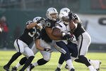 OAKLAND, CA - JANUARY 01:  Mike Tolbert #35 of the San Diego Chargers is tackled by Tyvon Branch #33, Desmond Bryant #90 and Tommy Kelly #93 of the Oakland Raiders at O.co Coliseum on January 1, 2012 in Oakland, California.  (Photo by Ezra Shaw/Getty Images)