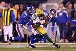 EAST RUTHERFORD, NJ - DECEMBER 04:  Greg Jennings #85 of the Green Bay Packers makes a reception against Aaron Ross #31 and Will Blackmon #36 of the New York Giants at MetLife Stadium on December 4, 2011 in East Rutherford, New Jersey.  (Photo by Al Bello/Getty Images)