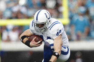 JACKSONVILLE, FL - JANUARY 1: Dallas Clark #44 of the Indianapolis Colts jumps over Akwasi Owusu-Ansah #41 of the Jacksonville Jaguars at EverBank Field on January 1, 2012 in Jacksonville, Florida. The Jaguars defeated the Colts 19-13. (Photo by Joe Robbins/Getty Images)