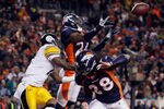 DENVER, CO - JANUARY 08:  Champ Bailey #24 of the Denver Broncos nearly intercepts a pass intended for Mike Wallace (L) #17 of the Pittsburgh Steelers, as Quinton Carter #28 of the Denver Broncos looks on during the AFC Wild Card Playoff game at Sports Authority Field at Mile High on January 8, 2012 in Denver, Colorado. The Broncos defeated the Steelers in overtime 23-29.  (Photo by Jeff Gross/Getty Images)