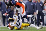 DENVER, CO - JANUARY 08:  Quinton Carter #28 of the Denver Broncos jumps over Mike Wallace #17 of the Pittsburgh Steelers during the AFC Wild Card Playoff game at Sports Authority Field at Mile High on January 8, 2012 in Denver, Colorado.  (Photo by Doug Pensinger/Getty Images)