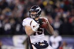 FOXBORO, MA - JANUARY 14:  Tim Tebow #15 of the Denver Broncos looks to pass against the New England Patriots during their AFC Divisional Playoff Game at Gillette Stadium on January 14, 2012 in Foxboro, Massachusetts.  (Photo by Elsa/Getty Images)
