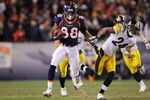 DENVER, CO - JANUARY 08:  Demaryius Thomas #88 of the Denver Broncos stiff arms Ike Taylor #24 of the Pittsburgh Steelers to score an 80 yard touchdown in overtime during the AFC Wild Card Playoff game at Sports Authority Field at Mile High on January 8, 2012 in Denver, Colorado. The Denver Broncos defeated the the Pittsburgh Steelers in over time 23 - 29.  (Photo by Doug Pensinger/Getty Images)