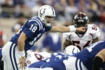 INDIANAPOLIS - JANUARY 9:  Quarterback Peyton Manning #18 of the Indianapolis Colts signals to his team against the Denver Broncos during the AFC Wildcard playoff game at the RCA Dome on January 9, 2005 in Indianapolis, Indiana.  The Colts won the game 49-24.  (Photo by Al Bello/Getty Images)
