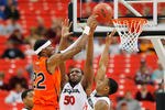 ATLANTA, GA - MARCH 10:  Kenny Gabriel #22 of the Auburn Tigers shoots over Gerald Robinson #22 and Jeremy Price #50 of the Georgia Bulldogs during the the first round of the SEC Men's Basketball Tournament at the Georgia Dome on March 10, 2011 in Atlanta, Georgia.  (Photo by Kevin C. Cox/Getty Images)