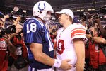 INDIANAPOLIS - SEPTEMBER 19:  Eli Manning #10 of the New York Giants and Peyton Manning #18 of the Indianapolis Colts embrace following the Colts 38-14 win at Lucas Oil Stadium on September 19, 2010 in Indianapolis, Indiana.  (Photo by Andy Lyons/Getty Images)