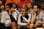 PHOENIX - APRIL 27:  Tim Duncan #21, Tony Parker #9 and Manu Ginobili #20 of the San Antonio Spurs sit on the bench against the Phoenix Suns during Game Four of the Western Conference Quarterfinals during the 2008 at NBA Playoffs at U.S. Airways Center April 27, 2008 in Phoenix, Arizona. NOTE TO USER: User expressly acknowledges and agrees that, by downloading and or using this photograph, User is consenting to the terms and conditions of the Getty Images License Agreement.  (Photo by Jed Jacobsohn/Getty Images)